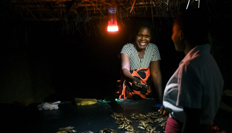 Margaret John in Malawi selling fish after dark.